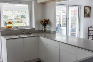 Design ideas for a modern kitchen in Other with flat-panel cabinets, light wood cabinets and quartz worktops.