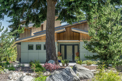 Mid-sized contemporary two-story concrete fiberboard house exterior idea in Seattle with a shed roof, a green roof and a gray roof