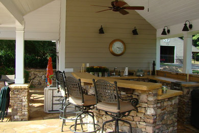 Example of a large country backyard stamped concrete and custom-shaped pool house design in Atlanta