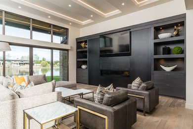 Living room - mid-sized modern open concept medium tone wood floor and brown floor living room idea in Boise with a media wall, beige walls and a ribbon fireplace