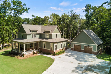 Mid-sized cottage green two-story vinyl and clapboard exterior home photo in Atlanta with a shingle roof and a brown roof