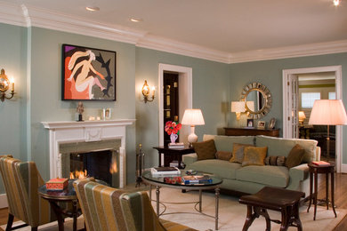 Inspiration for a mid-sized timeless formal and open concept dark wood floor and brown floor living room remodel in San Diego with blue walls, a standard fireplace, a plaster fireplace and no tv