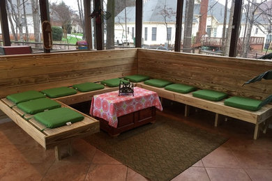 Mid-sized arts and crafts concrete screened-in back porch photo in Charlotte with a roof extension
