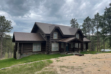 Mid-sized rustic three-story house exterior idea in Other with a shingle roof and a brown roof