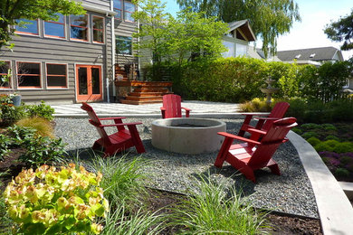 Design ideas for a mid-sized contemporary backyard partial sun garden for summer in Seattle with a fire feature and gravel.