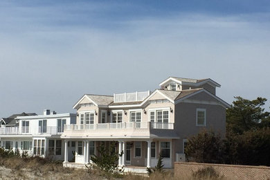 Photo of a beach style exterior in Philadelphia with wood siding and a gable roof.