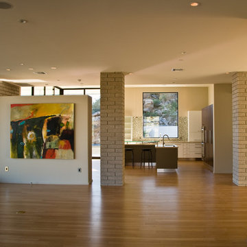 artwork before furnitures, kitchen and pool beyond