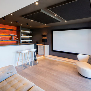 Inspiration for a small contemporary open concept medium tone wood floor home theater remodel in Grenoble with gray walls and a projector screen