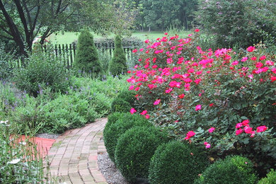 Large traditional backyard garden in Baltimore with a garden path and brick pavers.