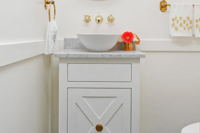 Example of a blue tile powder room design in Charleston with white walls