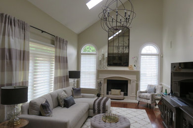 Mid-sized transitional open concept family room in New York with beige walls, medium hardwood floors, a standard fireplace and a concrete fireplace surround.