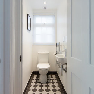 Design ideas for a small contemporary cloakroom in London with black and white tiles, white walls, porcelain flooring, a wall-mounted sink and a two-piece toilet.