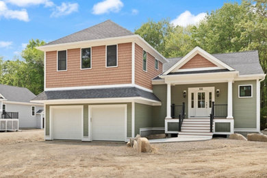 Large traditional green one-story vinyl and clapboard house exterior idea in Providence with a hip roof, a shingle roof and a black roof