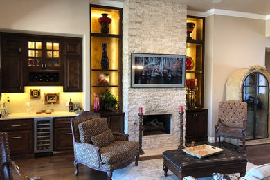 Eat-in kitchen - mid-sized transitional l-shaped dark wood floor and brown floor eat-in kitchen idea in Oklahoma City with raised-panel cabinets, black cabinets, granite countertops, stainless steel appliances, an island and multicolored countertops