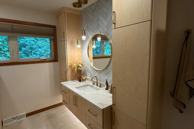 Example of a large trendy master gray tile and ceramic tile ceramic tile, beige floor and single-sink bathroom design in Other with flat-panel cabinets, light wood cabinets, a bidet, beige walls, an undermount sink, quartzite countertops, white countertops, a niche and a freestanding vanity