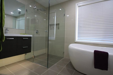 Design ideas for a medium sized contemporary family bathroom in Glasgow with a hot tub, a corner shower, beige walls, concrete flooring, beige floors and an open shower.