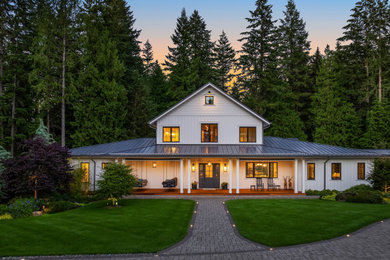 Large country white two-story wood and board and batten house exterior photo in Seattle with a hip roof, a metal roof and a gray roof