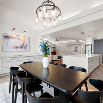 Transitional dining room with walnut table and orbital chandelier