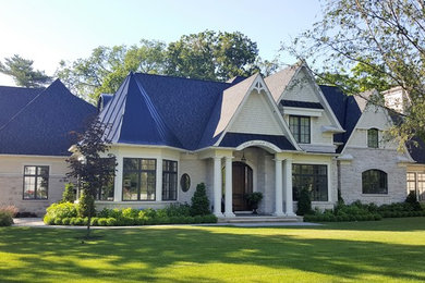 Huge traditional gray two-story mixed siding exterior home idea in Toronto with a mixed material roof