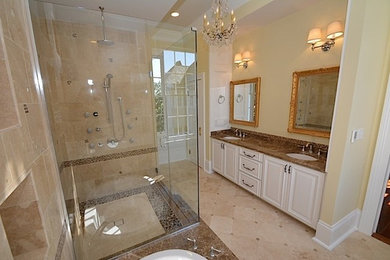 Example of a large classic master beige tile corner shower design in New Orleans with a drop-in sink, white cabinets and yellow walls