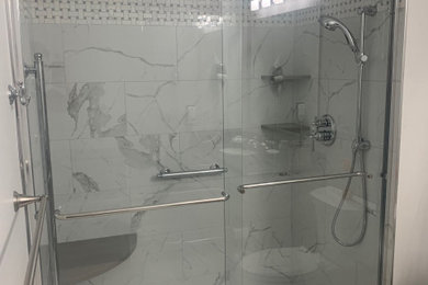 Example of a classic master porcelain tile mosaic tile floor bathroom design in Boston with gray walls, quartz countertops and gray countertops