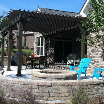 Attached cedar pergola with fire pit area.