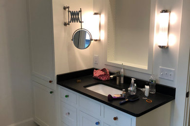 Bathroom - large craftsman master white floor and single-sink bathroom idea in Boston with recessed-panel cabinets, white cabinets, a two-piece toilet, an undermount sink, quartz countertops, black countertops and a built-in vanity