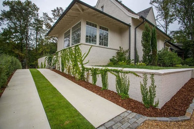 This is an example of a mid-sized traditional partial sun front yard concrete paver landscaping in Birmingham for summer.