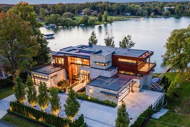 Huge trendy multicolored two-story mixed siding exterior home photo in Miami with a metal roof