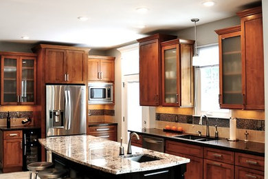 Transitional l-shaped kitchen photo in DC Metro with shaker cabinets, medium tone wood cabinets and stainless steel appliances