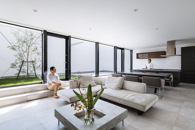 This is an example of a mid-sized modern open concept living room in Osaka with ceramic floors and a wall-mounted tv.