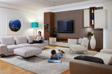 This is an example of a contemporary living room in Perth with white walls, medium hardwood floors and a wall-mounted tv.