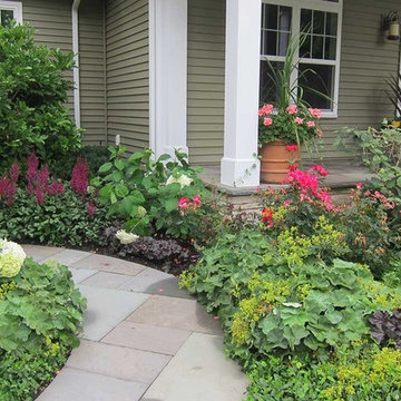 Generous plantings line the bluestone walkway with season-long color