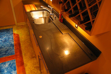 Inspiration for a small galley concrete floor enclosed kitchen remodel in Detroit with an undermount sink, flat-panel cabinets, light wood cabinets, stainless steel appliances and no island