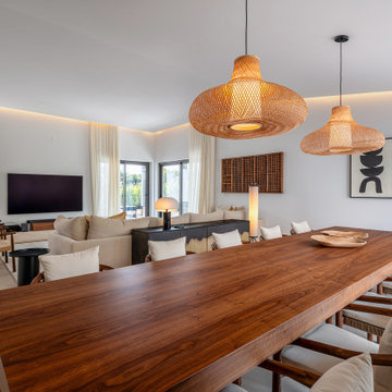 Dining room with long wood table and living room view, Alfragide