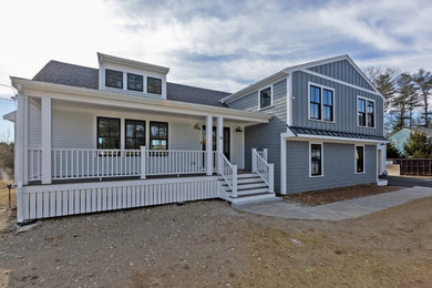 Large country gray split-level concrete fiberboard and clapboard exterior home photo in Boston with a shingle roof and a gray roof