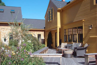 This is an example of a mid-sized farmhouse full sun backyard landscaping in Boston for summer.