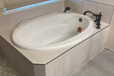 Inspiration for a mid-sized modern master gray tile and porcelain tile ceramic tile, beige floor and double-sink bathroom remodel in Other with raised-panel cabinets, medium tone wood cabinets, a two-piece toilet, beige walls, an undermount sink, granite countertops, a hinged shower door, white countertops and a built-in vanity