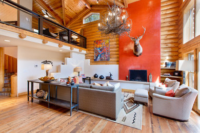 Living room - mid-sized rustic formal and open concept light wood floor living room idea in Albuquerque with a standard fireplace, a plaster fireplace and no tv