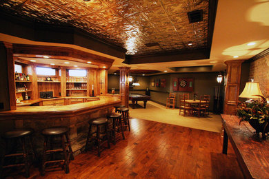 This is an example of a large country look-out basement in Atlanta with medium hardwood floors and brown floor.