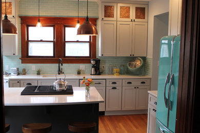 Mid-sized transitional medium tone wood floor kitchen photo in Other with an undermount sink, shaker cabinets, white cabinets, quartz countertops, blue backsplash, subway tile backsplash and an island