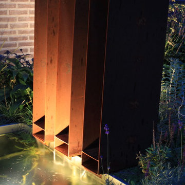 Backgarden with waterfeature and fireplace