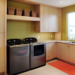 Inspiration for a medium sized contemporary l-shaped utility room in Toronto with a built-in sink, flat-panel cabinets, light wood cabinets, green walls and a side by side washer and dryer.