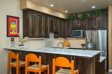Small transitional l-shaped vinyl floor and brown floor eat-in kitchen photo in Portland with an undermount sink, raised-panel cabinets, dark wood cabinets, quartzite countertops, white backsplash, subway tile backsplash, stainless steel appliances, no island and white countertops