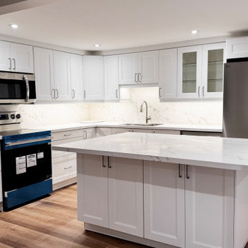 Bright White Transitional Kitchen with Quartz Peninsula and Full Slab Backsplash