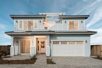 Coastal blue two-story house exterior idea in San Luis Obispo with a hip roof and a tile roof