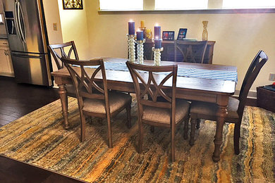 Kitchen/dining room combo - mid-sized coastal dark wood floor and brown floor kitchen/dining room combo idea in Jacksonville with yellow walls and no fireplace