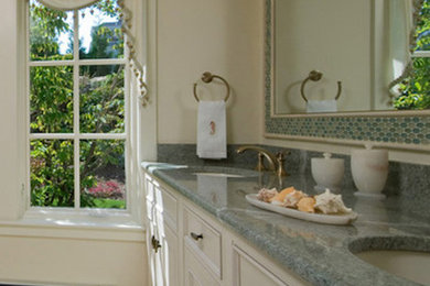 Bathroom - white tile ceramic tile bathroom idea in Boston with a drop-in sink, raised-panel cabinets and granite countertops