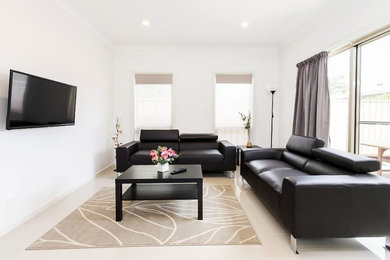 This is an example of a small traditional living room in Adelaide with white walls, ceramic floors, a wall-mounted tv and beige floor.