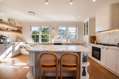 Photo of a country eat-in kitchen in Sydney with a single-bowl sink, shaker cabinets, white cabinets, marble benchtops, marble splashback and with island.